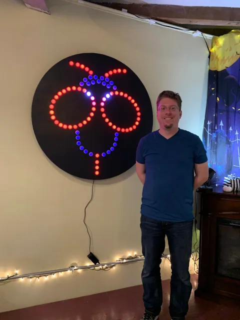 Branden posing by his Blinky Bee LED sign