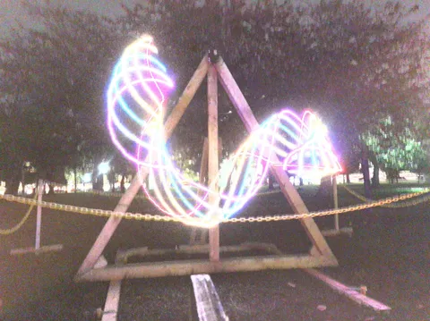 A time lapse photo of the Created Equal triple pendulum swinging