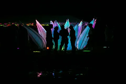 People standing in front of the glowing Crypto Lotus